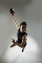 Handball player posing on light gray background. Girl jumping with ball Royalty Free Stock Photo