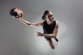 Handball player posing on light gray background. Girl jumping with ball Royalty Free Stock Photo