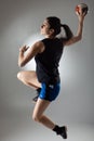 Handball player posing on light gray background. Girl jumping with ball Royalty Free Stock Photo