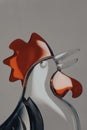 Handblown glass rooster sculpture against a gray background