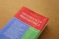 Handbook of Paediatrics textbook on a wooden table Royalty Free Stock Photo