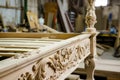 handcarved wooden bed frame with detailed headboard in a workshop