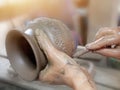 Handcraft artist making pattern on earthenware pottery
