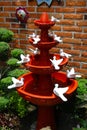 Handcraft fountain made of clay with many white doves