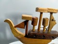 The handcraft wooden boat is displaying on the right side of background surface texture