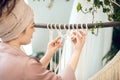 Young woman in a headwear weaving macrame and looking involved