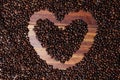 Handcrafted arrangement of coffee beans shaped to resemble a heart, symbol of love to commemorate Valentine\'s Day. Royalty Free Stock Photo
