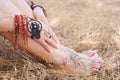 Handcrafted bracelets on a woman legs and hands, dreamcatcher jewelry