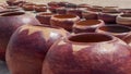 Handcrafted brown clay pots used for storage of dry produce. Location: Namibia