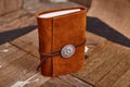 Handcrafted brown leather journal with concho on wood boards