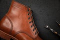 Handcrafted brown leather shoe with cobbler tools