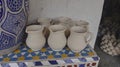 handcrafted ceramic pottery jugs standing on colorful table Royalty Free Stock Photo