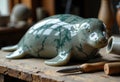 Handcrafted ceramic turtle sculpture with green marble pattern on a rustic Royalty Free Stock Photo