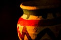 Handcrafted earthen pot again dark background. Clay vase made out of mud on dark background Royalty Free Stock Photo