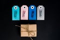 Handcrafted gift boxes wrapped in Craft paper with blue and pink paper card tag, rope and wooden clothespins for decoration Royalty Free Stock Photo