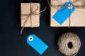 Handcrafted gift boxes wrapped in Craft paper with blue and pink paper card tag, rope and wooden clothespins for decoration Royalty Free Stock Photo