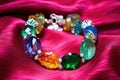 handcrafted glass charm bracelet on a velvet cushion