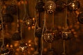 Handcrafted hanging lanterns made from natural materials with intricate perforated patterns. Warm glowing light creates Royalty Free Stock Photo