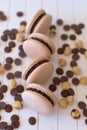 Handcrafted Macarons in Natural Tones Unadorned by Colorants Surrounded by Black and White Chocolate Pins