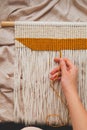 Handcrafted macrame wall hanging, close-up view.