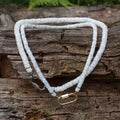 Handcrafted mother of pearl necklaces from polished pieces on natural wooden background