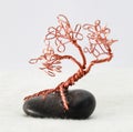 Handcrafted and painted wire tree attached to rock Royalty Free Stock Photo