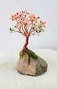 Handcrafted and painted wire tree for fall  attached to rock Royalty Free Stock Photo