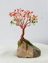 Handcrafted and painted wire tree for fall  attached to rock Royalty Free Stock Photo