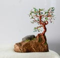 Handcrafted and painted wire tree for spring  attached to rock Royalty Free Stock Photo