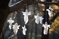 handcrafted paper ghosts hanging from a tree branch