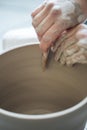 Handcrafted on a potter`s wheel,Hands make clay from various items for home and sale in the store and at the exhibition Royalty Free Stock Photo