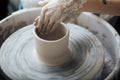 Handcrafted on a potter`s wheel,Hands make clay from various items for home and sale in the store and at the exhibition Royalty Free Stock Photo