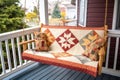 handcrafted quilt displayed on a charming porch swing
