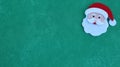 Handcrafted Santa Claus isolated on a green background