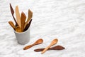 Handcrafted wooden utensils in a concrete cup Royalty Free Stock Photo