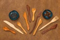 Handcrafted wooden utensils and spices on leather background