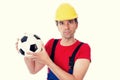 Handcrafter with helmet and drilling machine and soccer ball