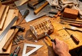 Handcrafting a miniature model house with tools and materials on a workshop table Royalty Free Stock Photo