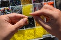 Handcrafts. Woman making seed bead jewellery