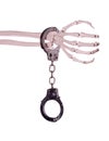 Handcuff and skeleton hand Royalty Free Stock Photo