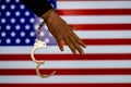 Handcuffed hand in front of the country flag. crime concept Royalty Free Stock Photo