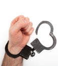 Handcuffed hand isolated on white background Royalty Free Stock Photo