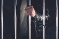 Handcuffed man behind prison bars Royalty Free Stock Photo