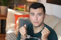 Handcuffed young man in the sofa Royalty Free Stock Photo