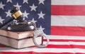 Handcuffs, book, judge gavel on the usa flag background