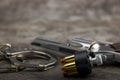 Handcuffs and Bullets with pistol handgun on texture background Royalty Free Stock Photo