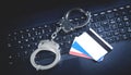 Handcuffs with credit cards on computer keyboard. Concept of Cyber crime and Online fraud Royalty Free Stock Photo