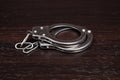 handcuffs on a dark background closeup,crime arrest