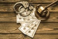 Handcuffs, dollar bills, a judge`s hammer against the background Royalty Free Stock Photo