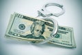 Handcuffs and dollar bills Royalty Free Stock Photo